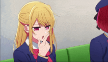 a girl with blonde hair and red eyes is making a face