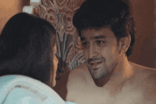 a man and a woman are looking at each other in the mirror .