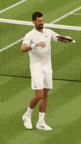 a man holding a tennis racquet on a court with a gatorade bottle in the background