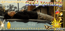 a picture of a man laying on top of a car with the words good morning written above him