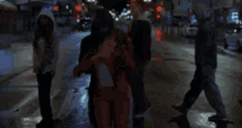 a man in a red suit is being held by a woman in a white shirt