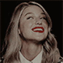 a close up of a woman 's face with red lipstick .