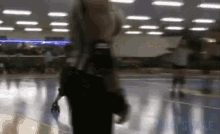 a blurry picture of people rollerblading in a rink with the word skate on the bottom right