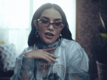 a woman wearing glasses and a shirt that says ' nc ' on it