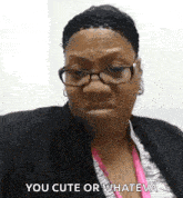 a woman wearing glasses and a pink lanyard is making a funny face .