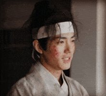 a man with a bandage on his head and a bun