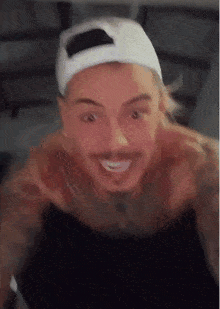 a shirtless man wearing a white hat is smiling and making a funny face .