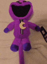 a purple stuffed animal with a tag that says " perry " on it
