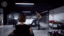 a woman sits in a chair while a man kicks her in the foot