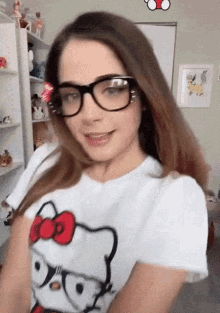 a woman wearing glasses and a hello kitty t-shirt
