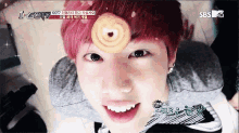a close up of a person with a cookie on their forehead