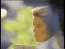a close up of a woman 's face with a cup of coffee in front of her