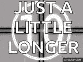 a sign that says just a little longer in white letters