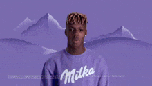 a man in a blue oreo shirt is holding a bar of oreo