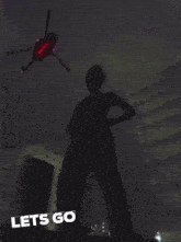 a helicopter is flying over a city at night and the words let 's go are below it
