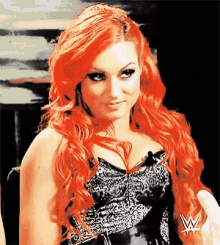 a woman with red hair is wearing a black and white top with the letter w on it