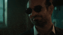 a man wearing sunglasses and a suit says " i like it "