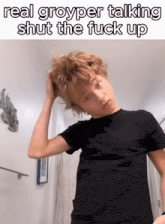 a young boy in a black shirt is holding his hair and the caption reads real groyper talking shut the fuck up