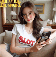 a woman sitting on a couch wearing a white shirt that says slot