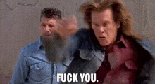 two men with beards are standing next to each other and one of them is giving the other a fist bump .