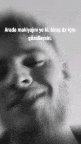 a blurry picture of a man 's face with the words arada makiyajını ye ki