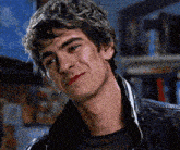 a close up of a man 's face with a black jacket on