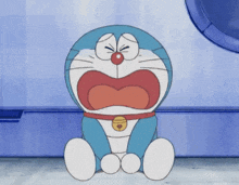 a cartoon character named doraemon is sitting on the floor with his mouth open