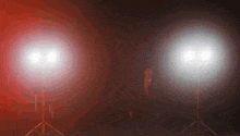 a couple of spotlights are lit up in the dark