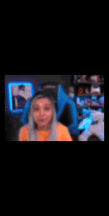 a girl is sitting in front of a computer with a headset that says akracing
