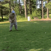 a man in a blue hat is swinging a golf club on a golf course