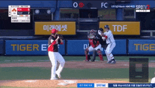a baseball game is being played in front of a sign that says tiger on it