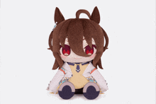 a stuffed animal with brown hair and red eyes is sitting on a white background