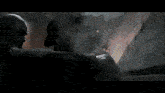 a close up of a person 's feet in a dark room with fire coming out of them