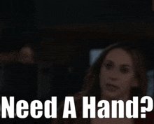 a woman says " need a hand " in front of her face
