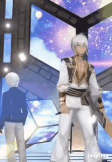 a man in a white outfit is standing in front of a large screen ..