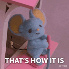a stuffed mouse is sitting on a pink shelf with the words that 's how it is netflix below it