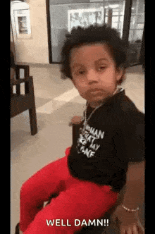a young boy is sitting on a chair in a waiting room .