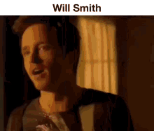 a man is standing in front of a window with his mouth open and the words `` will smith '' above him .