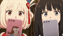 two anime girls are looking at their phones and one has an owl case on her phone