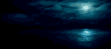 a full moon shines brightly over the ocean at night
