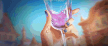 a woman is holding a glass of purple liquid in her hand .