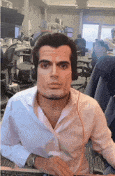 a man wearing headphones is sitting in an office