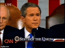 a man is speaking into a microphone in front of a cnn sign that says state of the union