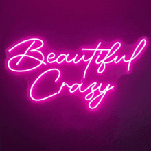a neon sign that says `` beautiful crazy '' is glowing in the dark on a purple background .