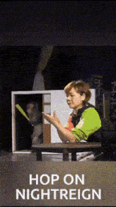 a woman is sitting at a table with a monkey behind her and the words hop on nightreign on the bottom