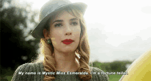 a woman in a hat says " my name is mystic miss esmeralda "