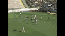 a group of soccer players on a field with a sign that says cdf on it