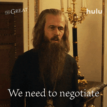 a man with a beard is standing in front of a candelabra and the words we need to negotiate