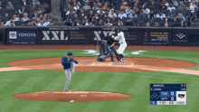 a baseball game is being played in front of a toyota advertisement