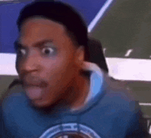 a close up of a man 's face with a surprised look on his face .